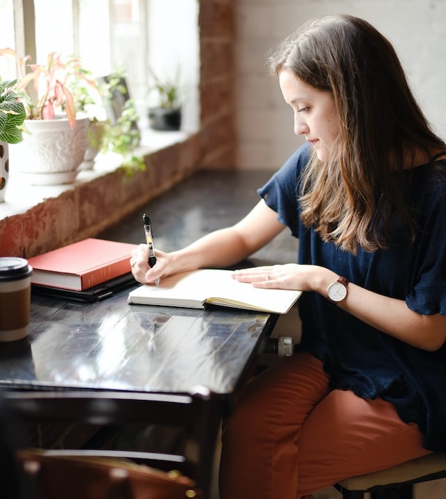 girl writing in a book