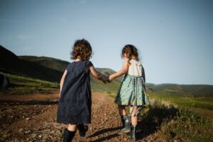 two kids holding hands