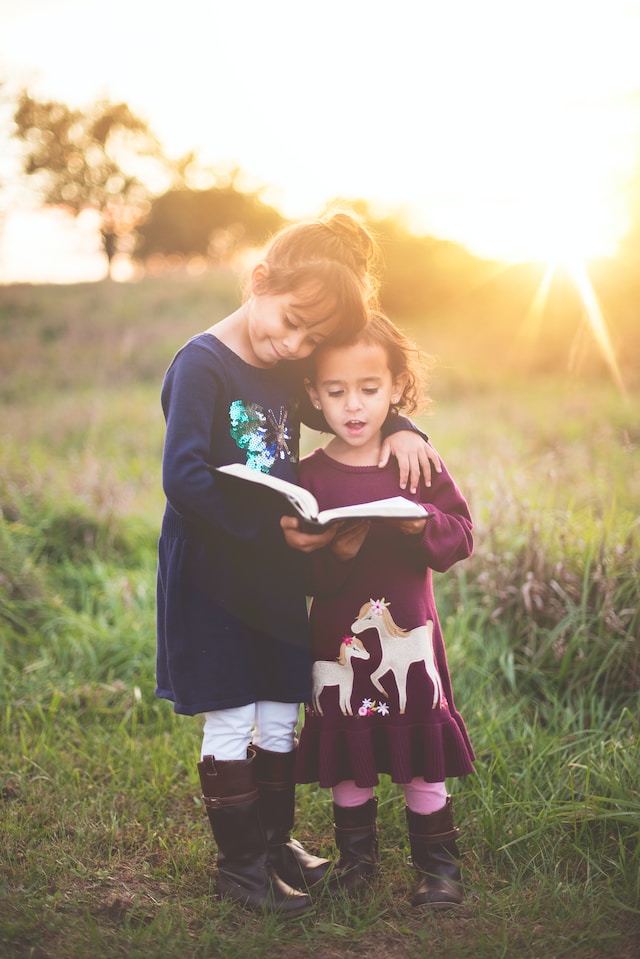 two kids reading a book