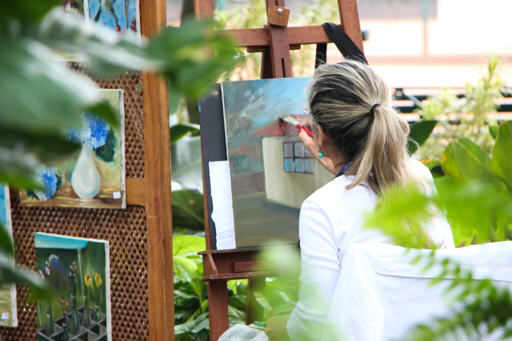 woman painting in an outside garden