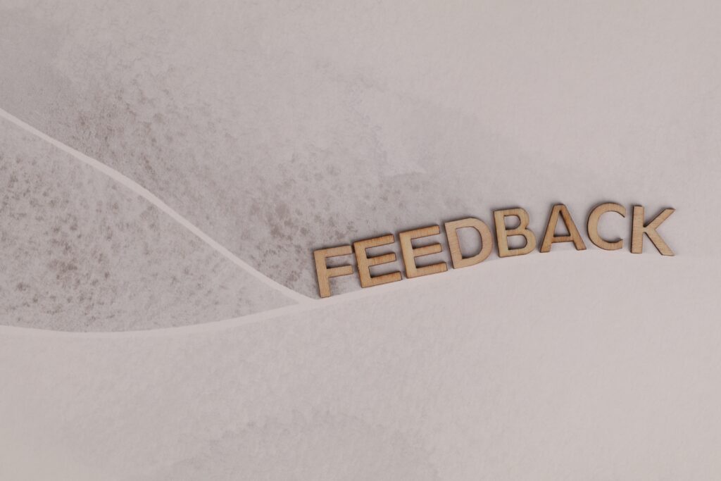 "Feedback" written in carved wooden letters