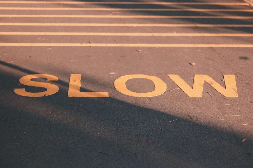 A road with the text "Slow" written in yellow on the road.