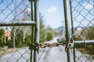 A chainlink fence blocks the road.