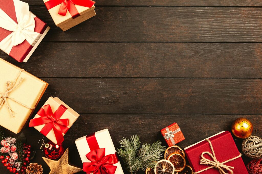 A photo of a wooden table with presents surrounding the frame