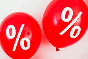 Two red balloons with "%" written on them.