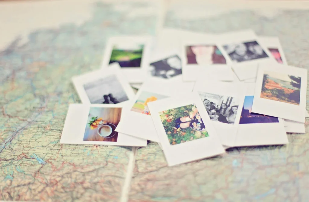 A pile of polaroid photos set on a map.