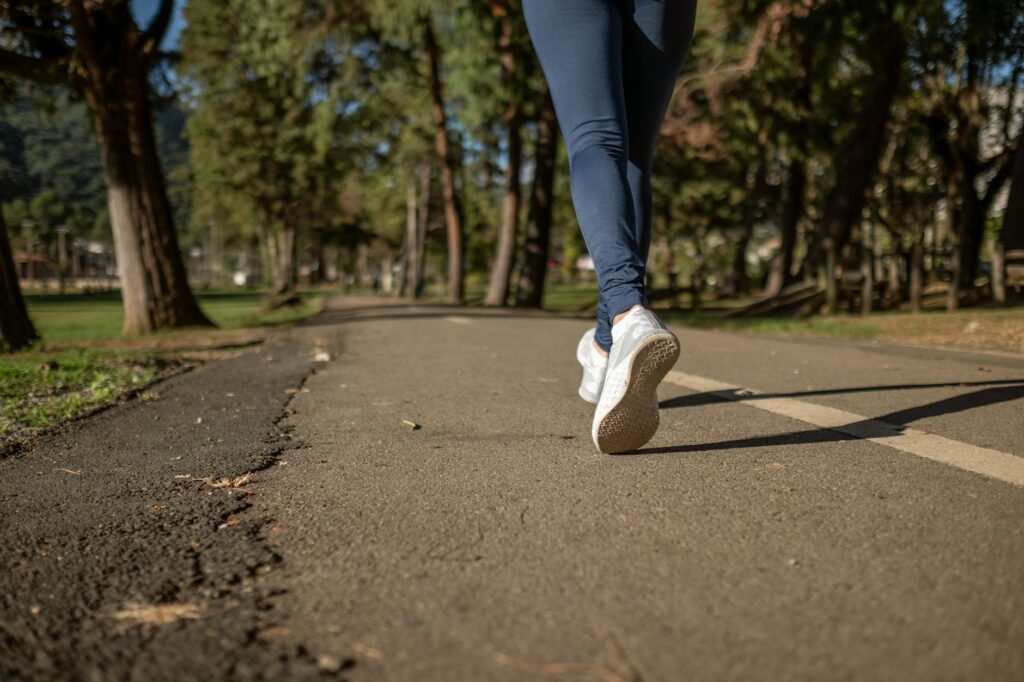 A close up of someone's feet as they walk down the road.