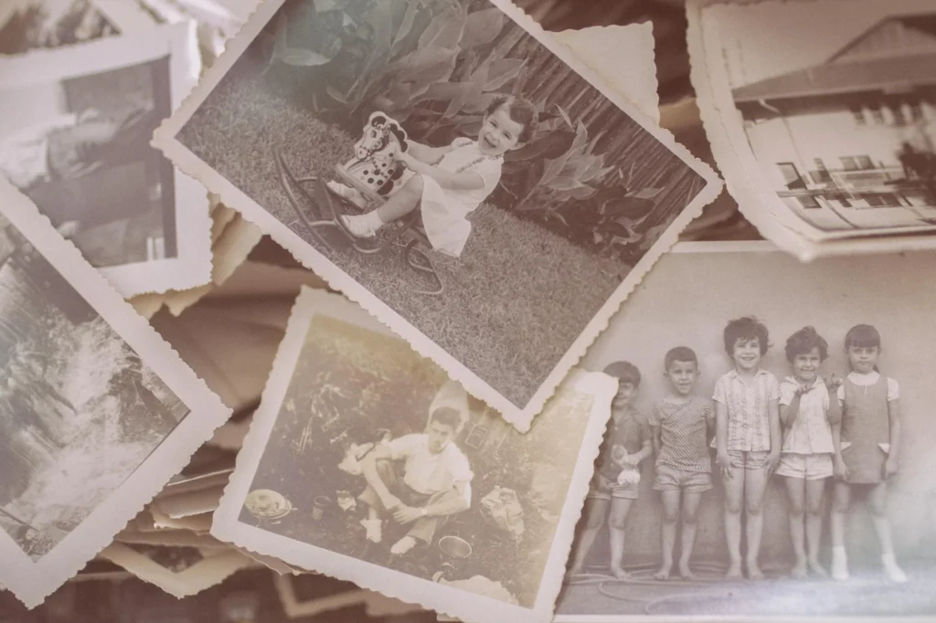 A collage pile of old, vintage photographs.